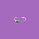 Simple brass ring featuring a blue circular accent