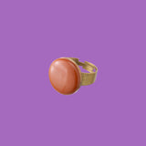 Hanmade ring featuring a thicker band and a round brick red decoration