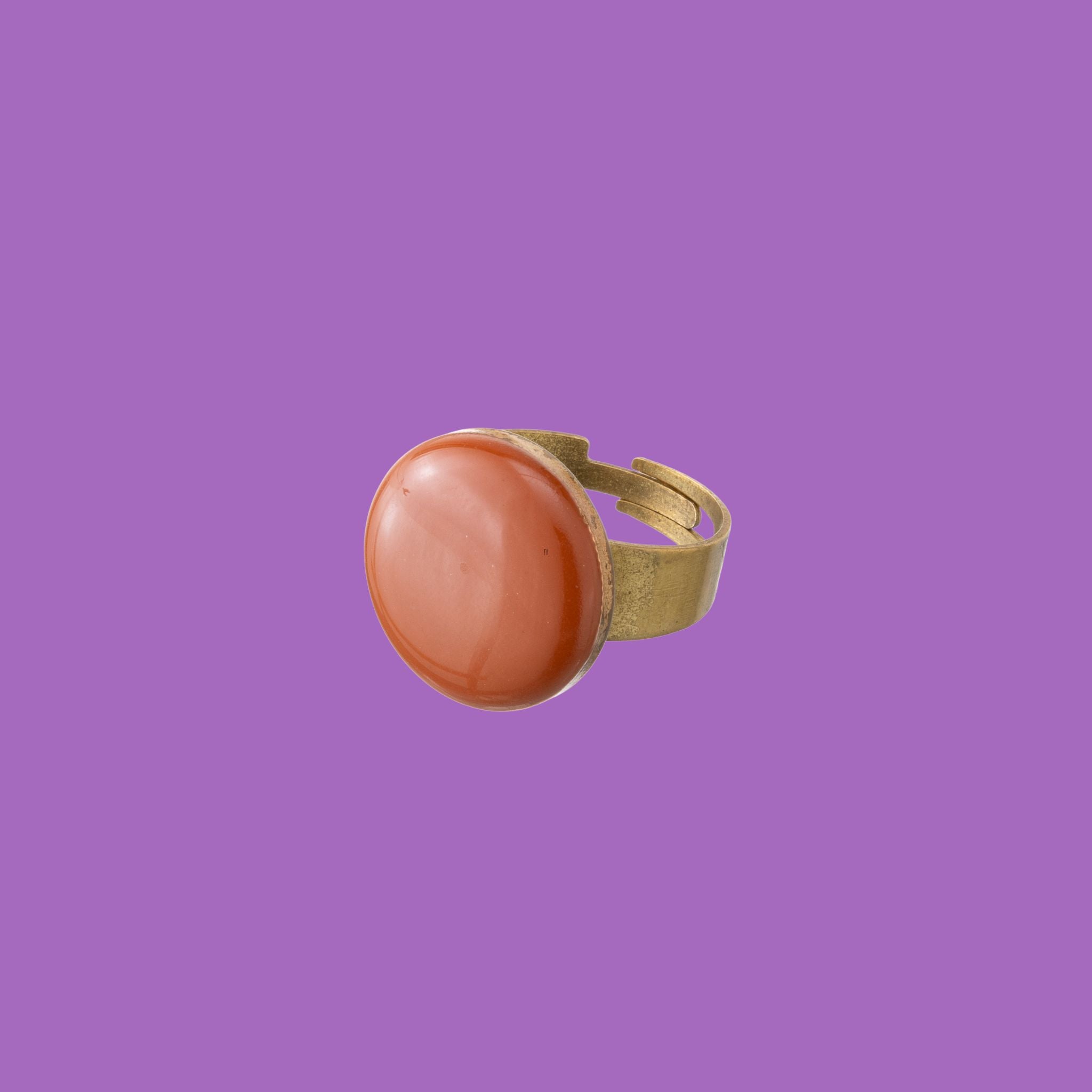 Hanmade ring featuring a thicker band and a round brick red decoration