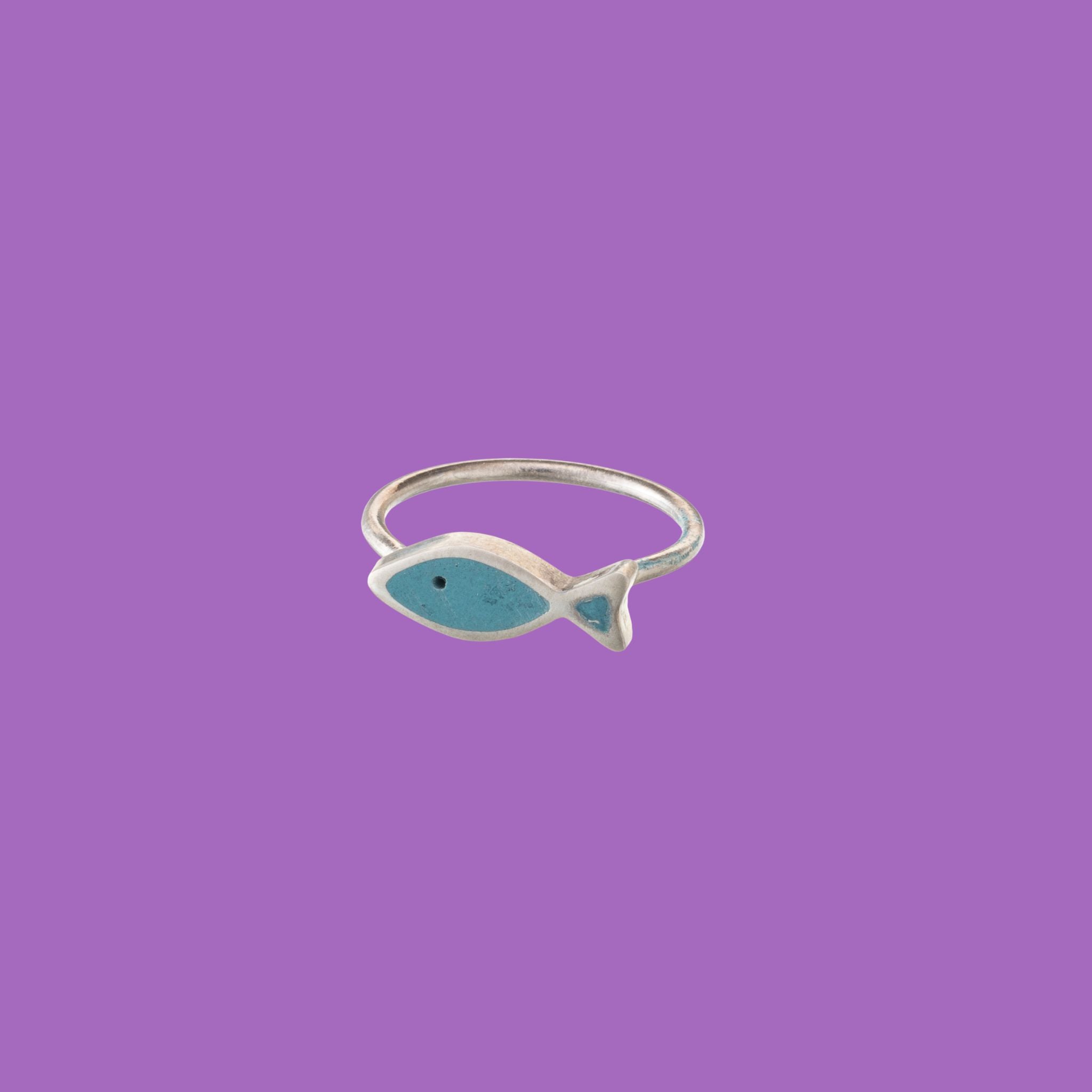 Handcrafted brass rings, shaped like graceful dark blue flounder fish
