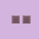 Handmade by Celeste Generoso, these enameled brass square earrings are available in light purple